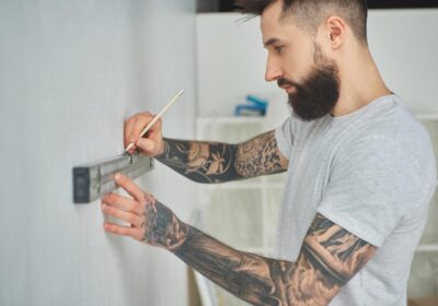 side-view-of-handsome-bearded-young-man-holding-level-tool-and-pencil-during-home-improvement-1024×683-1