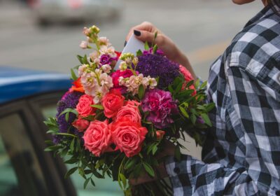 woman-holding-bouquet-colorful-roses-taking-greeting-card-hand-street_11zon